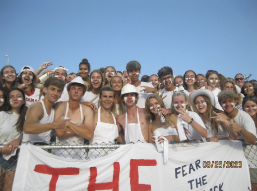 August 25, 2023. The Cardinal Crazies and other students cheer on the TWHS Football team against rival school Kilbourne in “The Cage”, a section of the Hamilton Field stands. 